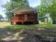 Exterior view of home showcasing a covered porch, situated on a grassy lot at 94 James Sw St, Concord, NC 28025
