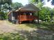 Exterior view of home showcasing a covered porch, situated on a grassy lot at 94 James Sw St, Concord, NC 28025