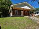 Charming home featuring a quaint front porch with wooden support beams and matching window shutters at 94 James Sw St, Concord, NC 28025