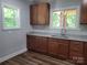 A bright kitchen featuring granite counters, stainless steel sink, and wood-look flooring at 94 James Sw St, Concord, NC 28025