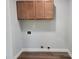 Laundry room with hardwood floors and overhead storage cabinets at 94 James Sw St, Concord, NC 28025