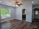 Bright living room with wood-look floors and large windows providing ample natural light at 94 James Sw St, Concord, NC 28025