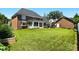 A spacious backyard with lush green lawn, mature trees, and a charming sunroom at 1009 13Th Avenue Nw Pl # 19, Hickory, NC 28601