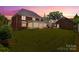 Expansive backyard featuring lush green lawn and a brick home with sunroom, perfect for outdoor enjoyment at 1009 13Th Avenue Nw Pl # 19, Hickory, NC 28601
