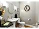 Cozy half-bathroom with stylish fixtures, round mirror and unique wall decor at 1009 13Th Avenue Nw Pl # 19, Hickory, NC 28601