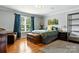 Bedroom with wood floors, a queen bed with green bedding, blue curtains, and natural light at 1009 13Th Avenue Nw Pl # 19, Hickory, NC 28601