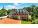 Beautiful brick home with black shutters, dormer windows, and a spacious brick driveway surrounded by mature trees at 1009 13Th Avenue Nw Pl # 19, Hickory, NC 28601