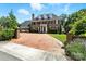 Stately brick home with mature landscaping, brick driveway, and classic black shutters under a sunny sky at 1009 13Th Avenue Nw Pl # 19, Hickory, NC 28601