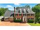 Charming brick home with manicured landscaping, black shutters, dormer windows, and a brick driveway at 1009 13Th Avenue Nw Pl # 19, Hickory, NC 28601