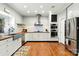 Modern kitchen with stainless steel appliances, white cabinets, subway tile backsplash, and butcher block countertops at 1009 13Th Avenue Nw Pl # 19, Hickory, NC 28601