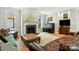 Cozy living room featuring a fireplace, hardwood floors, piano and stylish furniture at 1009 13Th Avenue Nw Pl # 19, Hickory, NC 28601