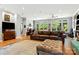 Bright living room featuring hardwood floors, large windows, and a comfortable leather sofa and ottoman at 1009 13Th Avenue Nw Pl # 19, Hickory, NC 28601