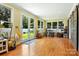 Sunroom featuring bright yellow walls, hardwood floors, and multiple windows with natural light at 1009 13Th Avenue Nw Pl # 19, Hickory, NC 28601