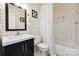 Modern bathroom with white subway tiles, a dark vanity and a shower with a white curtain at 1040 Goshen Pl, Charlotte, NC 28211