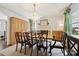 Well-lit dining room with fireplace, hardwood floors, and a grand wooden china cabinet at 1040 Goshen Pl, Charlotte, NC 28211