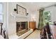 Dining room boasts a white brick fireplace, hardwood floors, a soft area rug and elegant decor at 1040 Goshen Pl, Charlotte, NC 28211