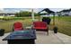 Inviting backyard patio area featuring stylish seating and a modern fire pit, perfect for outdoor gatherings at 1047 Campbell Chase Sw Ln, Concord, NC 28025