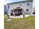 Spacious backyard featuring a modern patio area with comfortable seating, ideal for relaxing and entertaining at 1047 Campbell Chase Sw Ln, Concord, NC 28025