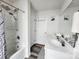 Bright bathroom with double sink vanity, updated fixtures, and a shower with tub at 1047 Campbell Chase Sw Ln, Concord, NC 28025