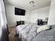 Cozy bedroom with large screen television, comfortable bed, and neutral décor at 1047 Campbell Chase Sw Ln, Concord, NC 28025