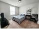 Cozy bedroom with neutral colors, a full-sized bed, and a large window at 1047 Campbell Chase Sw Ln, Concord, NC 28025