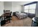 Comfortable bedroom featuring a work desk, neutral décor, and natural light at 1047 Campbell Chase Sw Ln, Concord, NC 28025