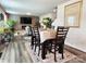 Elegant dining area with a large wooden table, seating for six, and a view into the spacious living room at 1047 Campbell Chase Sw Ln, Concord, NC 28025