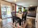 Charming dining area with a table set for six, sliding glass doors to a patio, and a view into the living room at 1047 Campbell Chase Sw Ln, Concord, NC 28025