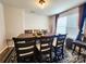 Traditional dining room with a dark wood table, chairs, and a large window for natural light at 1047 Campbell Chase Sw Ln, Concord, NC 28025