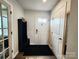 Bright entryway featuring a hall tree, coat rack, and a door with glass inserts at 1047 Campbell Chase Sw Ln, Concord, NC 28025