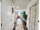 Bright hallway featuring a runner rug, glass paneled doors, and a view of the living area at 1047 Campbell Chase Sw Ln, Concord, NC 28025