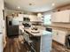 Bright kitchen featuring stainless steel appliances, a kitchen island with bar stools, and modern white cabinetry at 1047 Campbell Chase Sw Ln, Concord, NC 28025