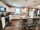 Well-lit kitchen featuring modern appliances, a kitchen island with bar stools, and ample counter space for food preparation at 1047 Campbell Chase Sw Ln, Concord, NC 28025