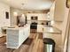 Modern kitchen with stainless steel appliances, a kitchen island with bar seating, and plenty of cabinet space at 1047 Campbell Chase Sw Ln, Concord, NC 28025