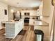 Modern kitchen with stainless steel appliances, a kitchen island with bar seating, and plenty of cabinet space at 1047 Campbell Chase Sw Ln, Concord, NC 28025