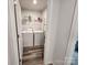 Functional laundry room with modern washer, dryer, and convenient shelving for storage at 1047 Campbell Chase Sw Ln, Concord, NC 28025