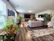 Beautiful living room with stone accent wall, modern fireplace, comfortable gray sectional, and plenty of natural light at 1047 Campbell Chase Sw Ln, Concord, NC 28025