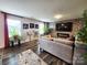 Bright living room features a stone accent wall, modern fireplace, sleek bar seating, and comfortable gray sofa at 1047 Campbell Chase Sw Ln, Concord, NC 28025