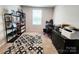 Functional home office with ample storage and shelving, workspace, and natural light at 1047 Campbell Chase Sw Ln, Concord, NC 28025