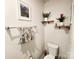 Chic powder room with floating shelves, a toilet, and a towel rack for an elegant touch at 1047 Campbell Chase Sw Ln, Concord, NC 28025