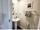 Stylish powder room with a pedestal sink, a large mirror, and decorative towels at 1047 Campbell Chase Sw Ln, Concord, NC 28025