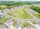 Neighborhood aerial showcasing a manicured common green space amidst well-maintained homes and winding streets at 1115 Macallum Nw Dr, Concord, NC 28027