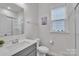 Bathroom featuring a single sink vanity, toilet, and glass enclosed shower at 1115 Macallum Nw Dr, Concord, NC 28027