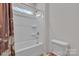 Bright bathroom features a shower with a floral curtain and a white toilet at 1115 Macallum Nw Dr, Concord, NC 28027