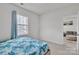 Well-lit bedroom with large window, and blue bedding, creating a relaxing and inviting space at 1115 Macallum Nw Dr, Concord, NC 28027