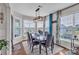 Dining area with large windows, modern lighting, and a stylish dining set at 1115 Macallum Nw Dr, Concord, NC 28027