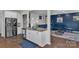 Kitchen island with sink and stainless fridge opens to the living room area at 1115 Macallum Nw Dr, Concord, NC 28027