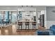 Open kitchen features a breakfast bar with wooden stools and granite countertops at 1115 Macallum Nw Dr, Concord, NC 28027