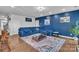 Comfortable living room with a plush blue sectional, modern coffee table, and a stylish accent wall at 1115 Macallum Nw Dr, Concord, NC 28027