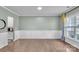 Spacious living room with hardwood floors, large windows, wainscoting and neutral wall color at 1115 Macallum Nw Dr, Concord, NC 28027